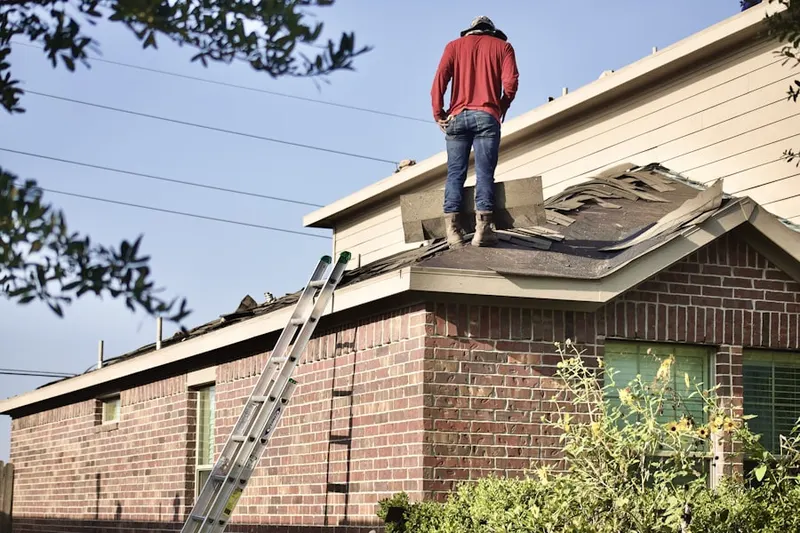 Professional roofer working on a residential roof in Lamson Corner
